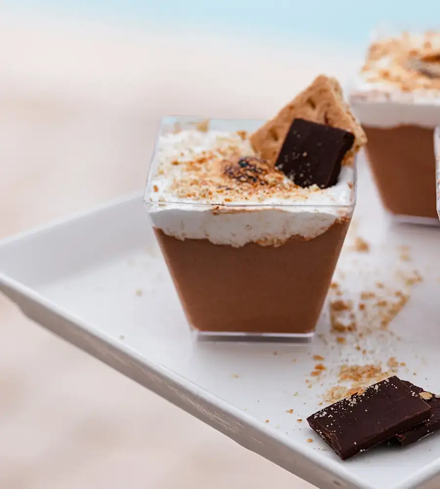 Dessert cup with chocolate mousse, whipped cream, and cookie on top.
